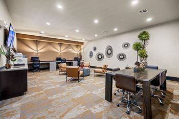 A conference room with a long table and chairs.